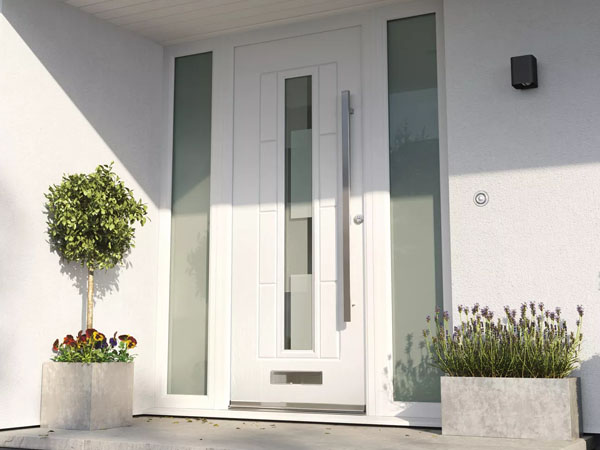 A white composite door framed by plants